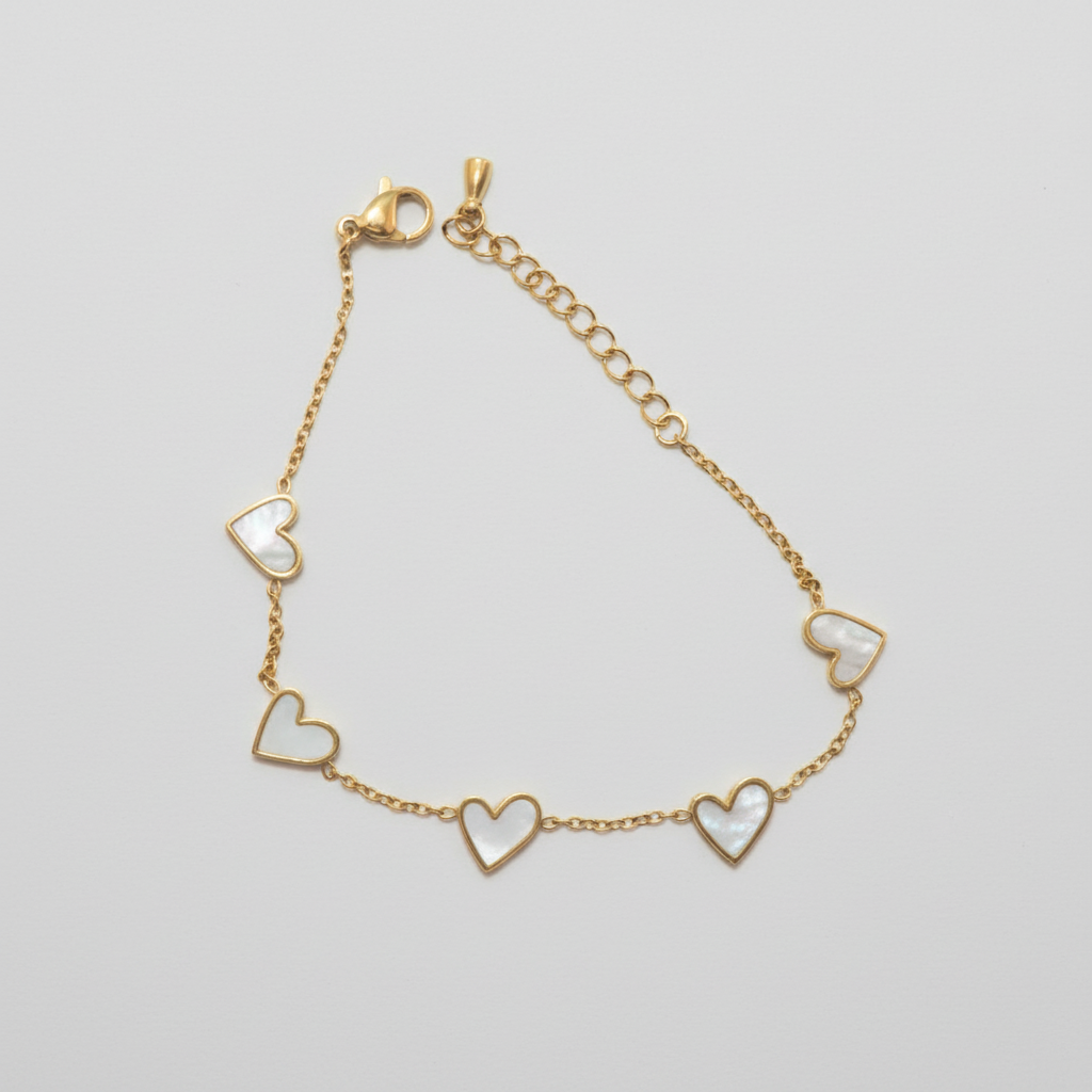 Gold bracelet with heart-shaped charms on a white background
