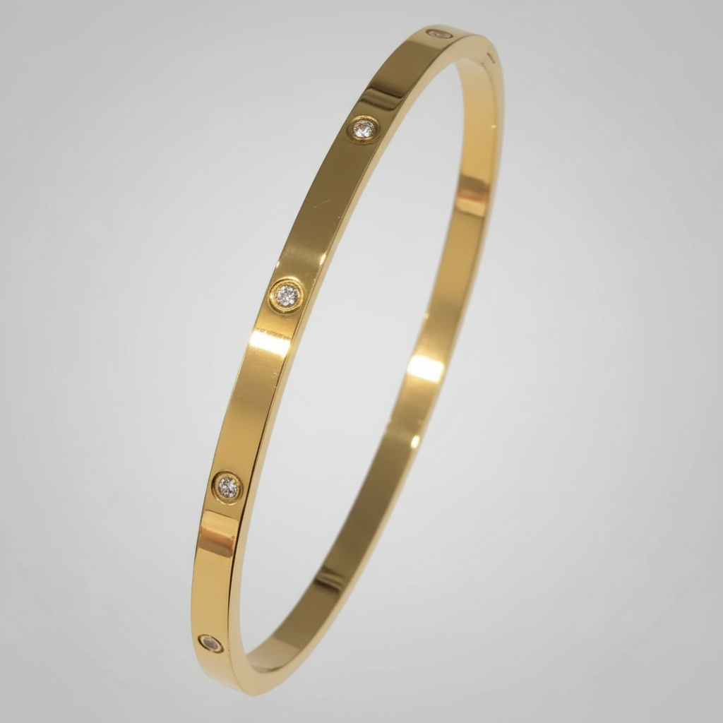 Gold bracelet with small diamonds on a white cushion