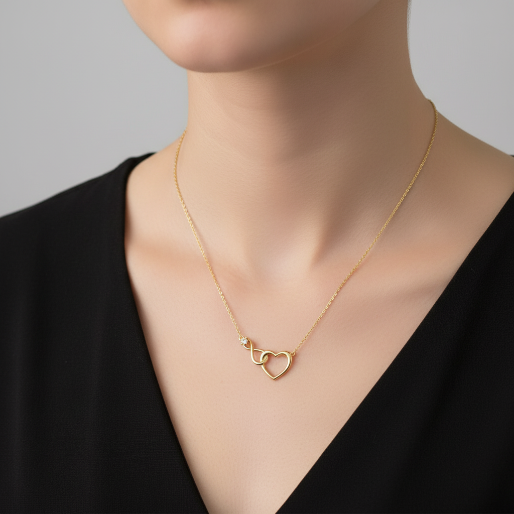 Gold heart-shaped necklace on a white background