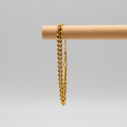 Gold chain on a wooden stand with a white background